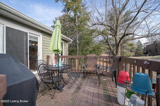 wooden terrace with outdoor dining space