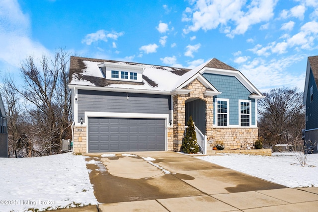 view of front of home featuring a garage and central air condition unit