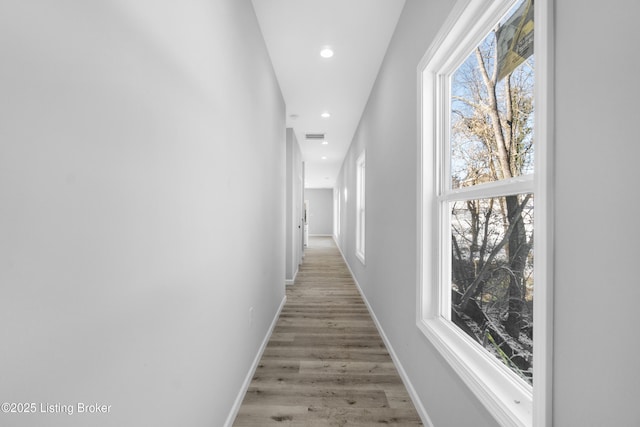 hallway with hardwood / wood-style flooring