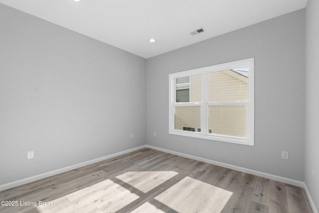 spare room with light hardwood / wood-style flooring