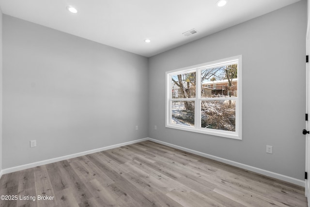 spare room with light wood-type flooring