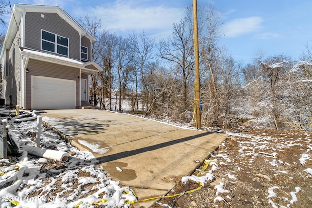 view of snow covered exterior with a garage