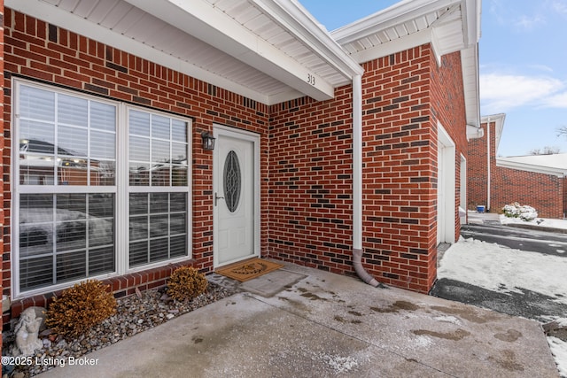 property entrance featuring brick siding