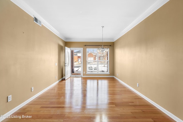 unfurnished dining area with baseboards, visible vents, ornamental molding, light wood-style floors, and a chandelier