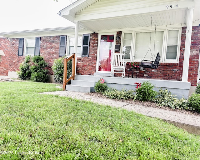 9914 Mccrea Ln, Louisville, KY 40229 - doorway to property with brick siding, a lawn, and a porch
