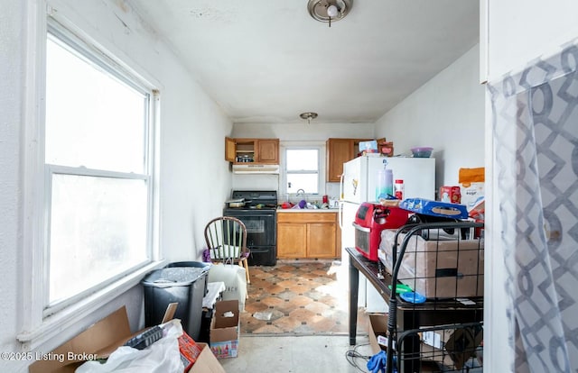 kitchen featuring white fridge and black electric range oven