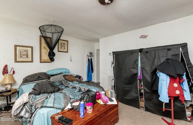 bedroom featuring a textured ceiling and light colored carpet