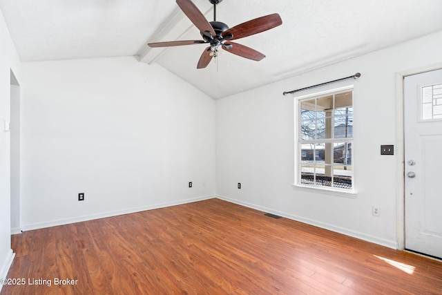 interior space featuring vaulted ceiling with beams, ceiling fan, and wood-type flooring