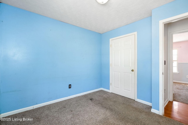 unfurnished bedroom featuring carpet and a textured ceiling