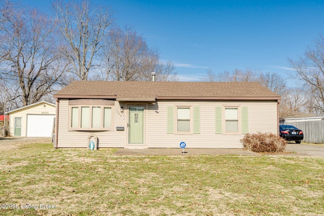 ranch-style house with an outdoor structure, roof with shingles, a detached garage, and a front yard