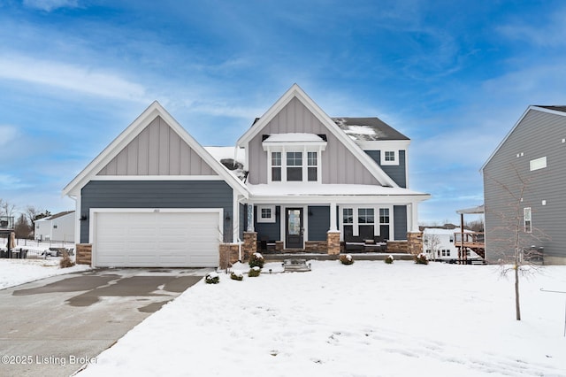 craftsman-style home featuring an attached garage, covered porch, and board and batten siding