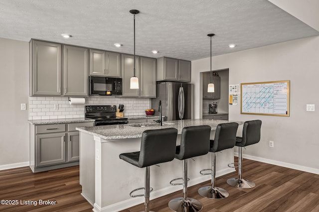 kitchen with dark wood-style flooring, gray cabinets, and black appliances