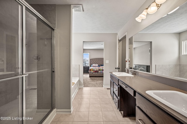 bathroom featuring a stall shower, a sink, ensuite bath, and visible vents