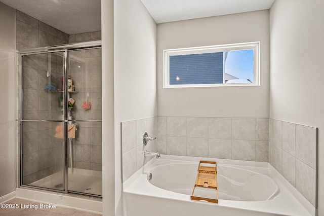 full bath featuring a shower stall and a bath
