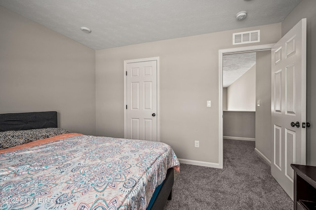 bedroom with visible vents, baseboards, carpet floors, and a textured ceiling