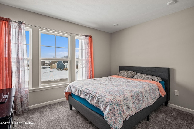 bedroom with baseboards and carpet flooring