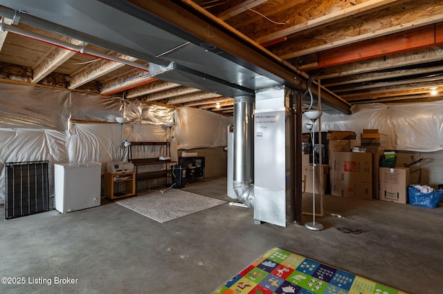 unfinished below grade area featuring refrigerator