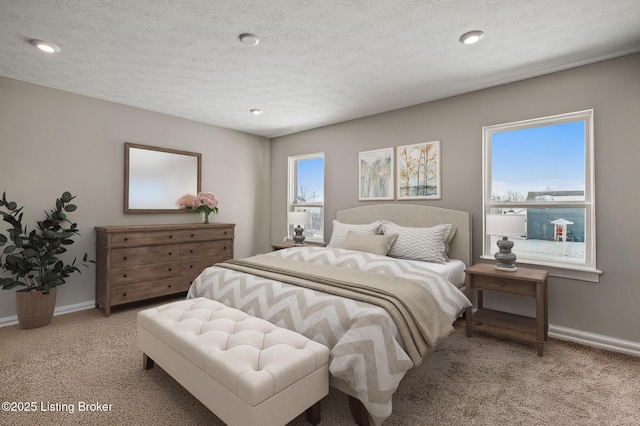 bedroom with baseboards, multiple windows, and light carpet