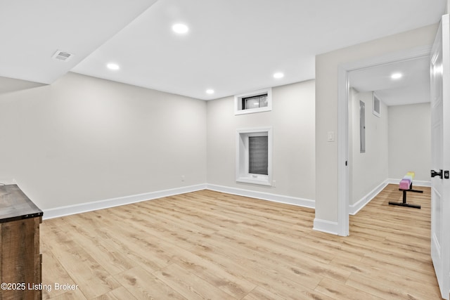 finished below grade area featuring baseboards, visible vents, light wood-style flooring, and recessed lighting