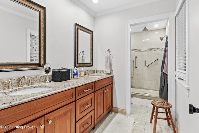 full bathroom featuring double vanity, ornamental molding, a stall shower, and a sink