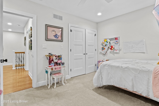 bedroom featuring recessed lighting, light colored carpet, visible vents, baseboards, and a closet