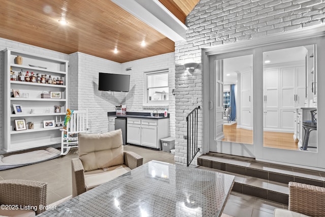 dining room featuring light tile patterned floors, brick wall, wood ceiling, built in shelves, and recessed lighting