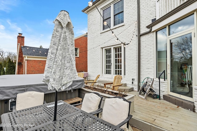 wooden terrace with outdoor dining area