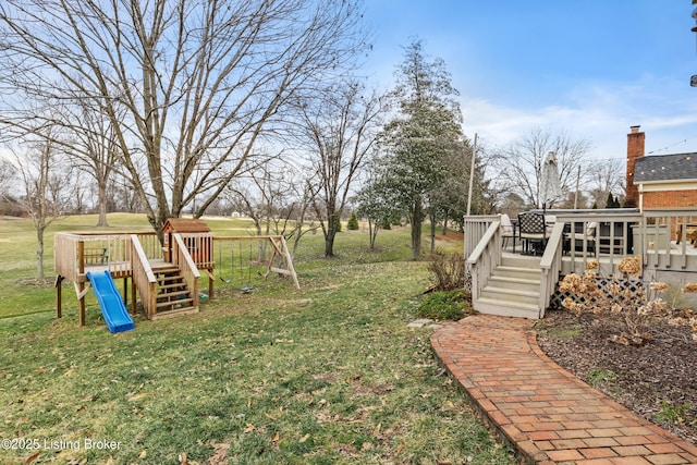 view of yard with a deck and a playground