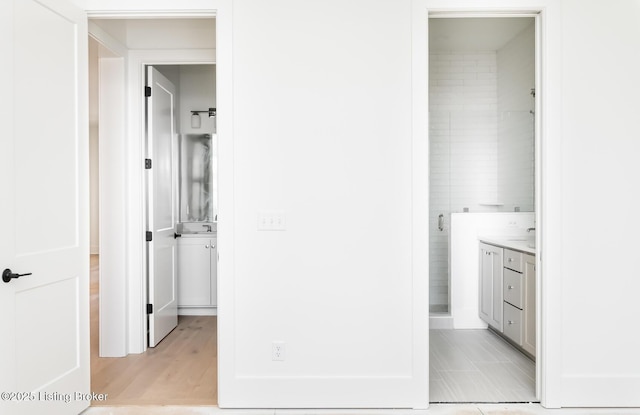 interior space featuring vanity and a shower with door