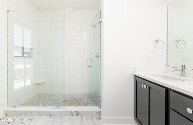 bathroom featuring vanity and a shower with door