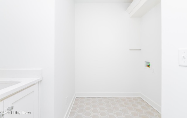 laundry area with washer hookup and light tile patterned floors