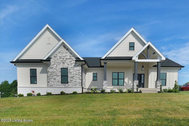 modern inspired farmhouse featuring stone siding, roof with shingles, board and batten siding, and a front yard