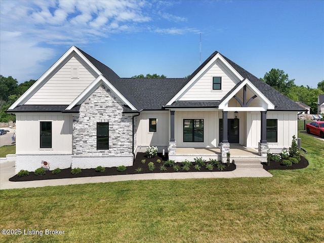 modern inspired farmhouse featuring board and batten siding, brick siding, a shingled roof, and a front lawn