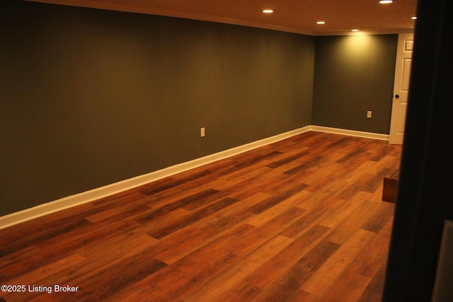 basement with crown molding and wood-type flooring