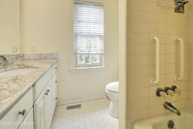 full bathroom with tile patterned flooring, toilet, vanity, visible vents, and baseboards