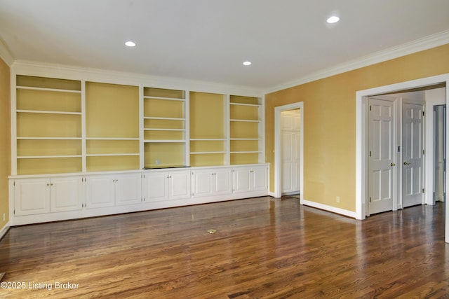 empty room with crown molding, baseboards, dark wood-type flooring, and recessed lighting