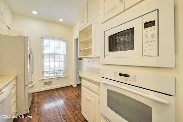 kitchen featuring dark wood-type flooring, white appliances, light countertops, and open shelves