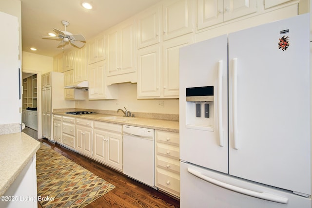 kitchen with dark wood-style floors, recessed lighting, light countertops, a sink, and white appliances