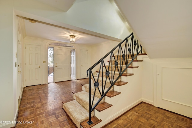 foyer with stairs and ornamental molding