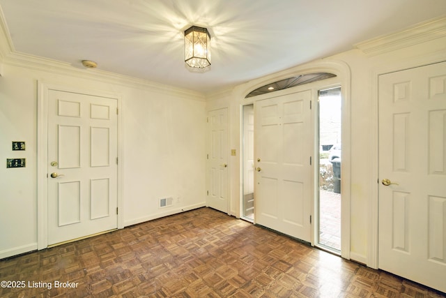 entryway featuring crown molding, visible vents, and plenty of natural light