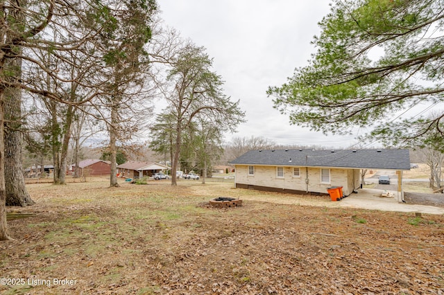 view of yard with a fire pit and a patio area