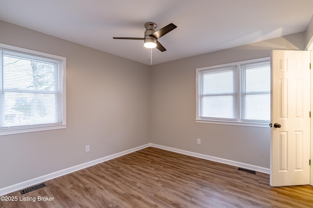 unfurnished room featuring ceiling fan and hardwood / wood-style floors