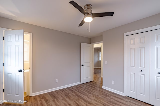 unfurnished bedroom featuring ceiling fan, light hardwood / wood-style flooring, and a closet