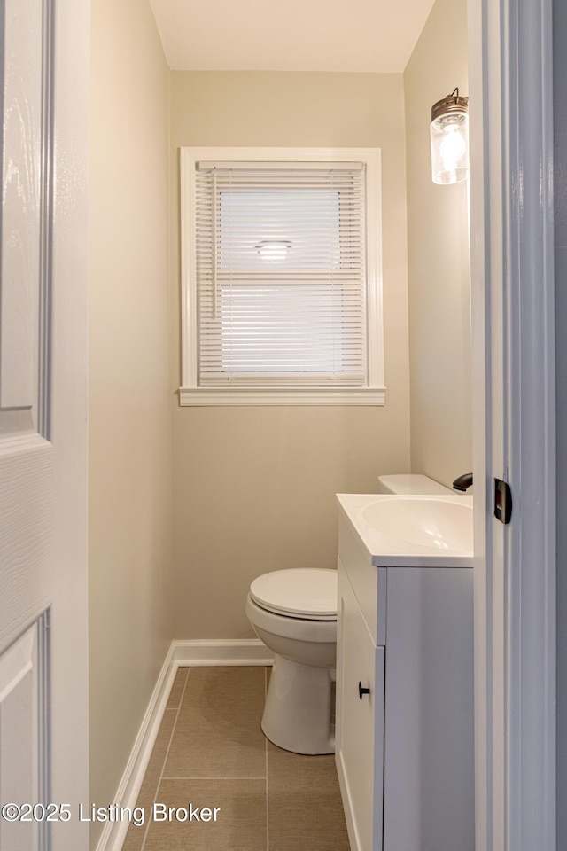 bathroom featuring vanity, tile patterned flooring, and toilet