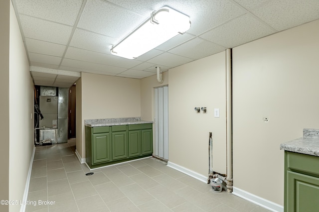 laundry room featuring heating unit and light tile patterned floors