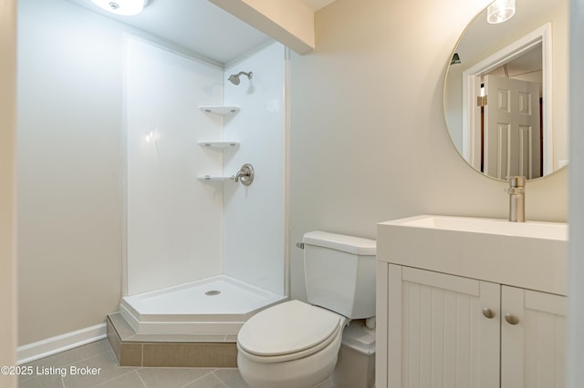bathroom with a shower, vanity, toilet, and tile patterned floors