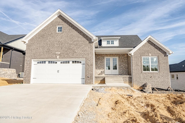 view of front of house with a garage and french doors