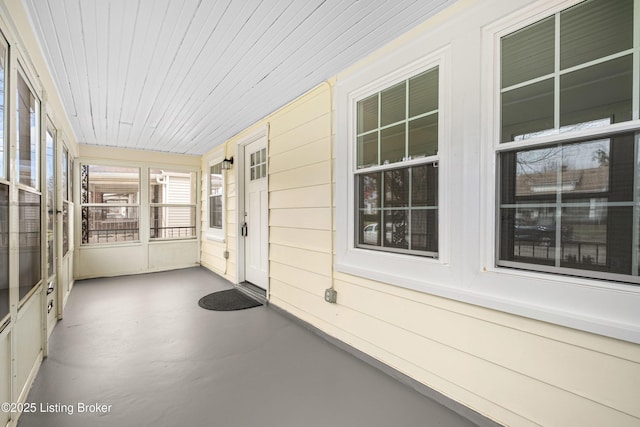 unfurnished sunroom with wood ceiling