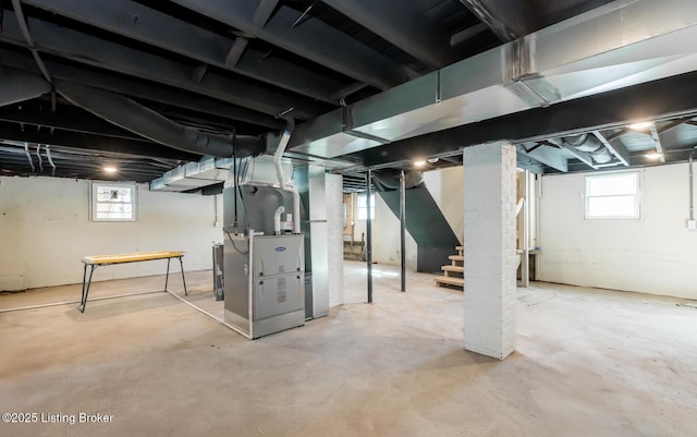 basement with heating unit and plenty of natural light