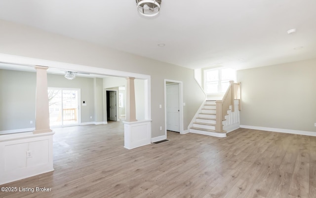 interior space with light wood-type flooring and decorative columns